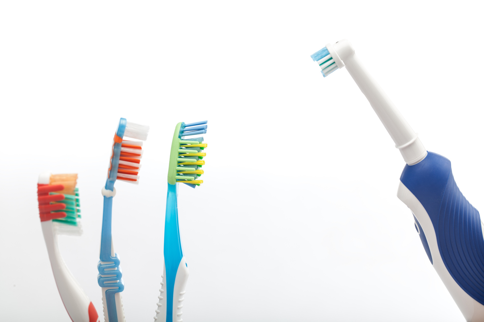 three toothbrushes with an electronic toothbrush