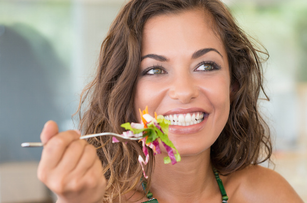 Young Smiling Girl Eating Salad