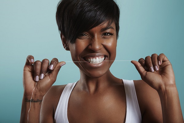happy girl have fun with a tooth floss. tooth care. white smile